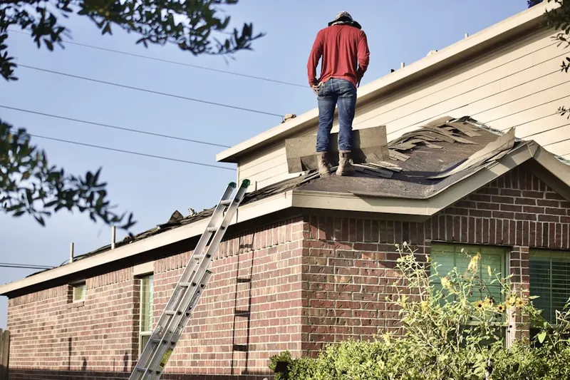 Professional roofer working on a residential roof in Aquasco